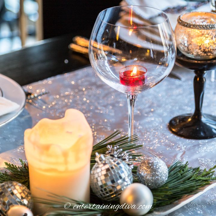 Christmas table with a wine glass used as a candle holder