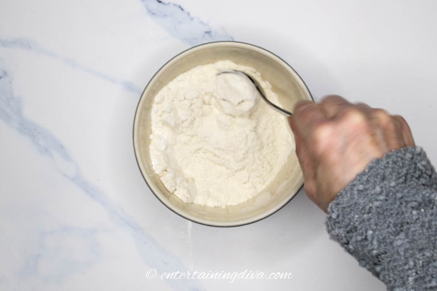Banana nut bread dry ingredients being mixed in a bowl