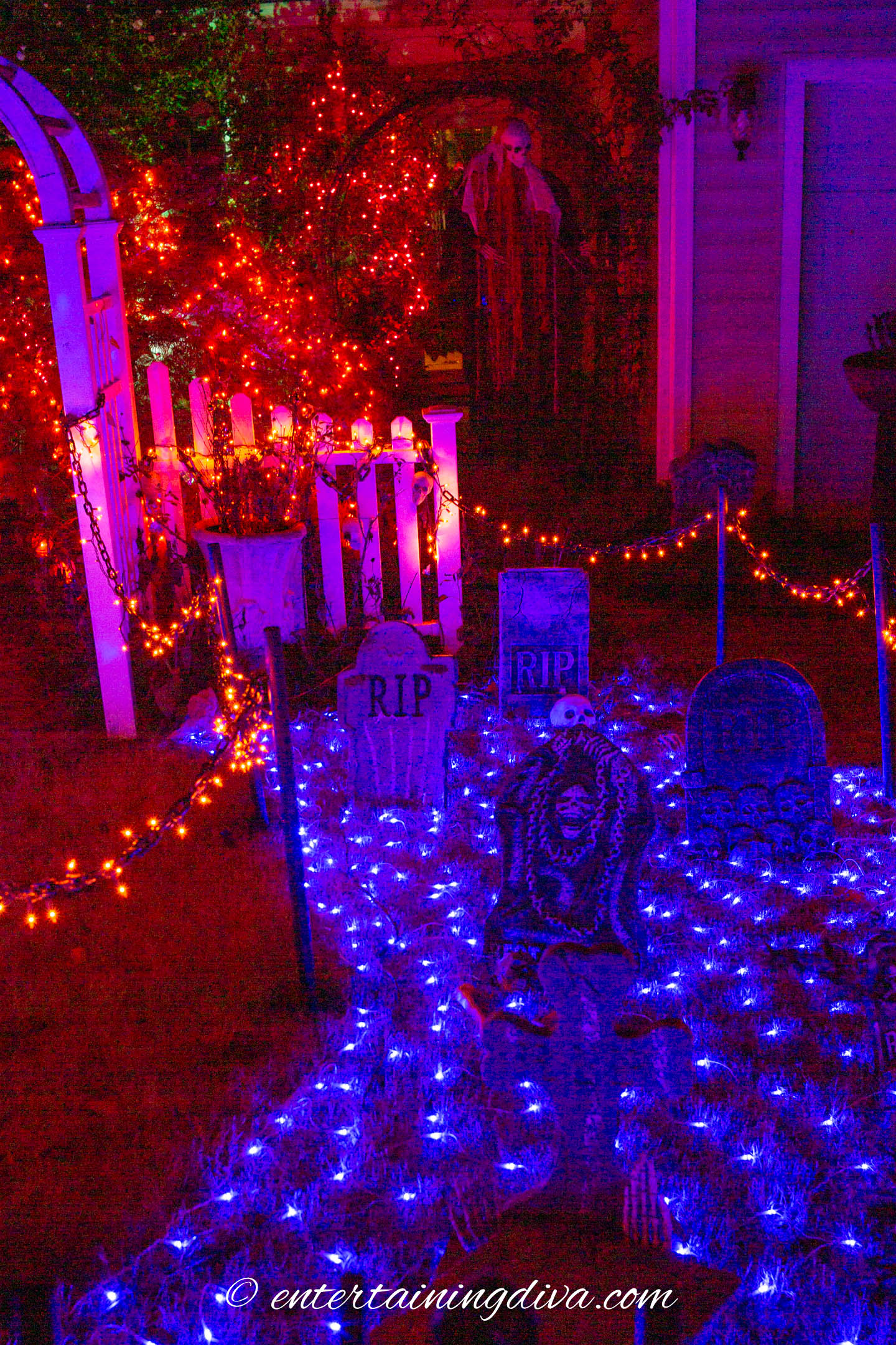 blue net light covering the ground under Halloween tombstones