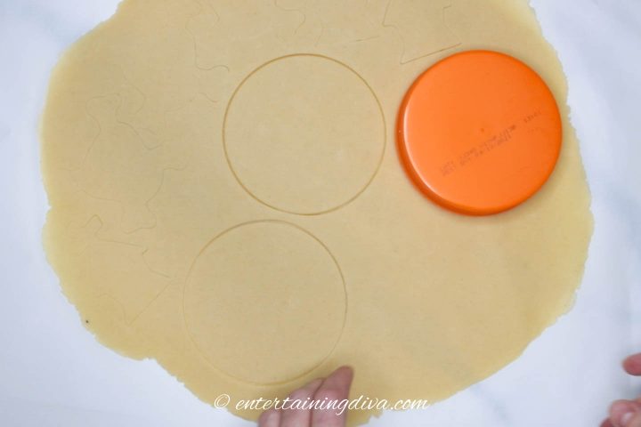 round shape being cut out of cookie dough