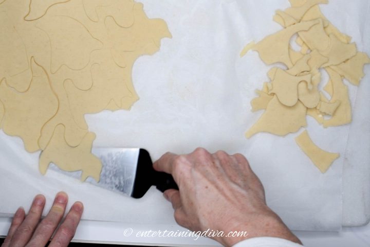 Spatula loosening cat cut-out from the cookie dough