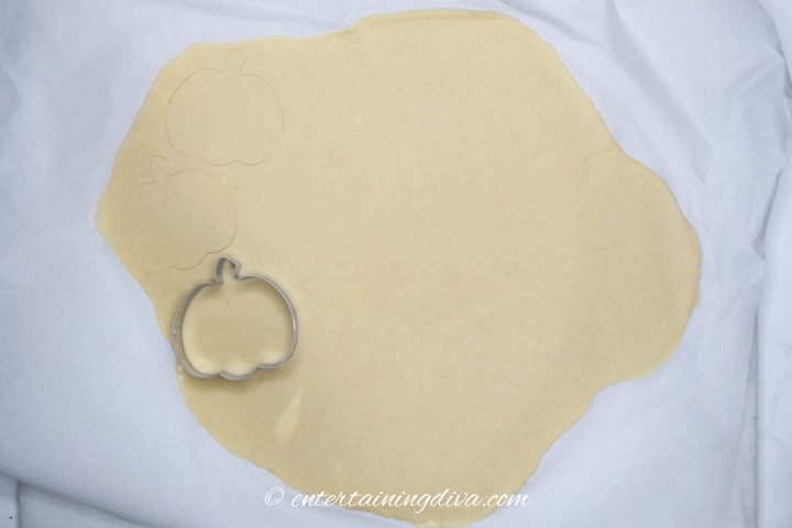 Pumpkin cookie cutter on cookie dough