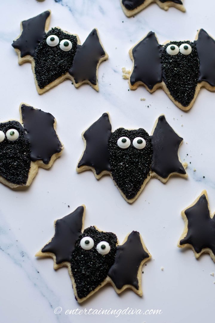 Larger Halloween bat sugar cookies with black royal icing, black sprinkles and candy eyes.
