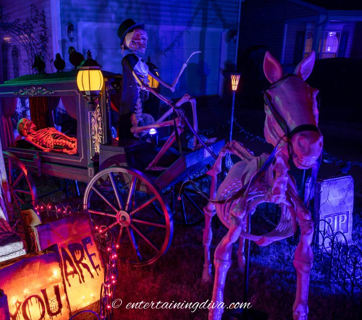 The Halloween skeleton horse and carriage lit up at night