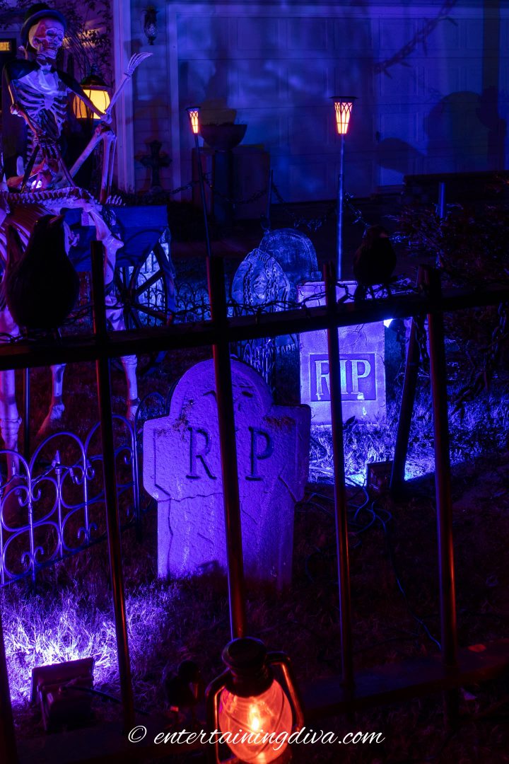 Halloween graveyard tombstones lit up with blue spot lights
