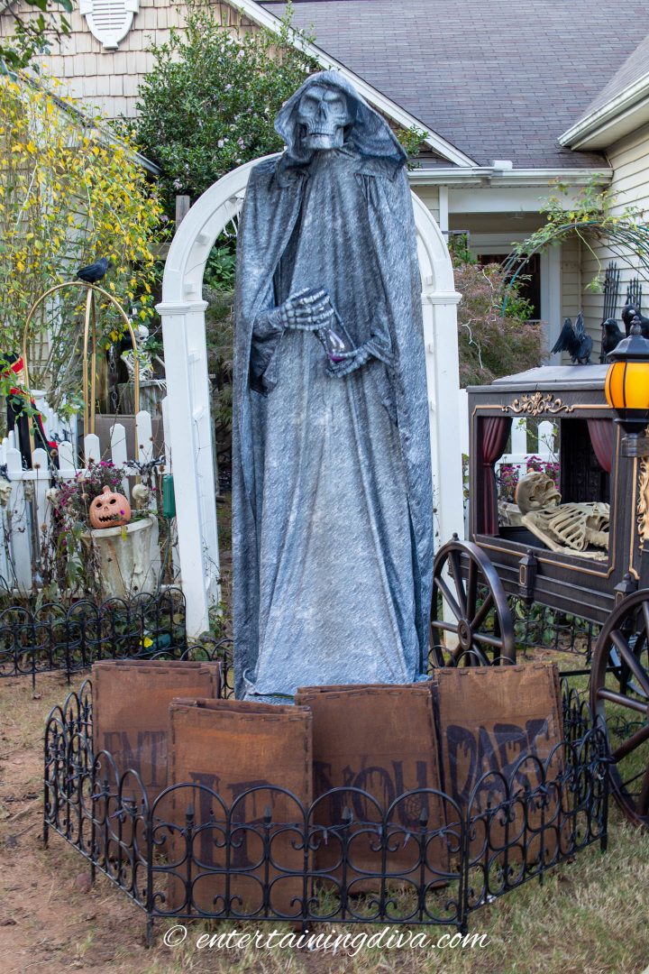 Large Halloween grim reaper statue in the middle of the yard