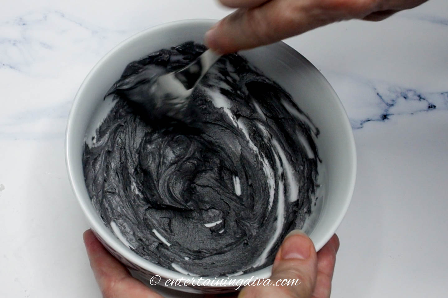 Black butter cream icing in a bowl