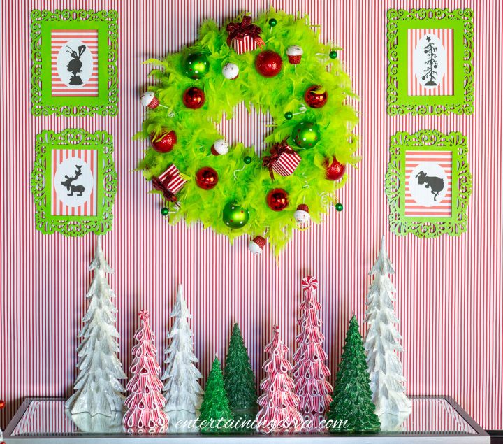 The DIY Grinch printable silhouette pictures hung on either side of a Grinch wreath.