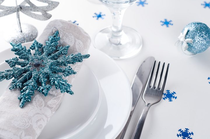 Christmas table setting with snowflake ornament as napkin holder