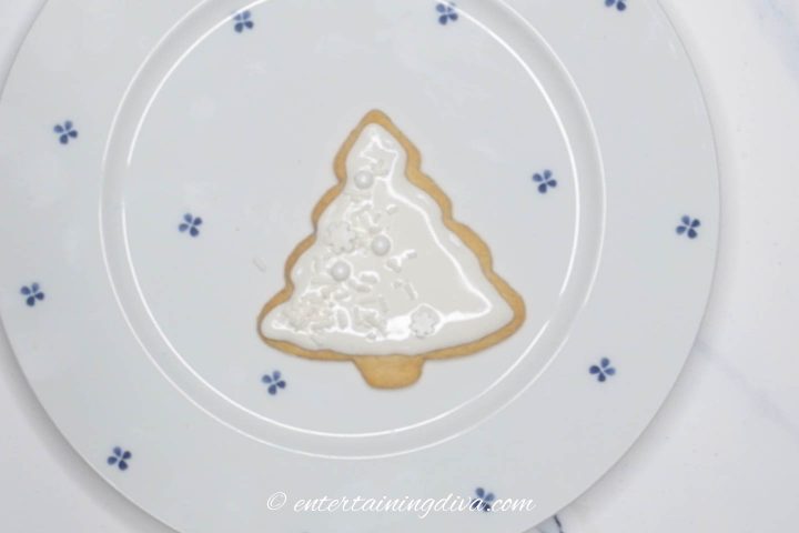 Christmas tree sugar cookies with white icing and white sprinkles
