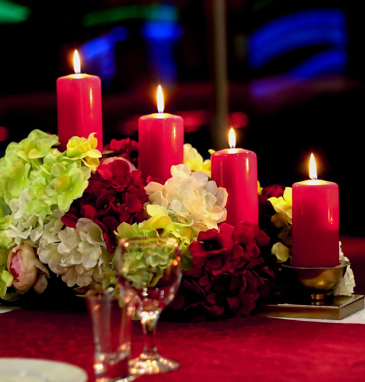 DIY Christmas centerpiece made of red and white faux hydrangeas with red pillar candles