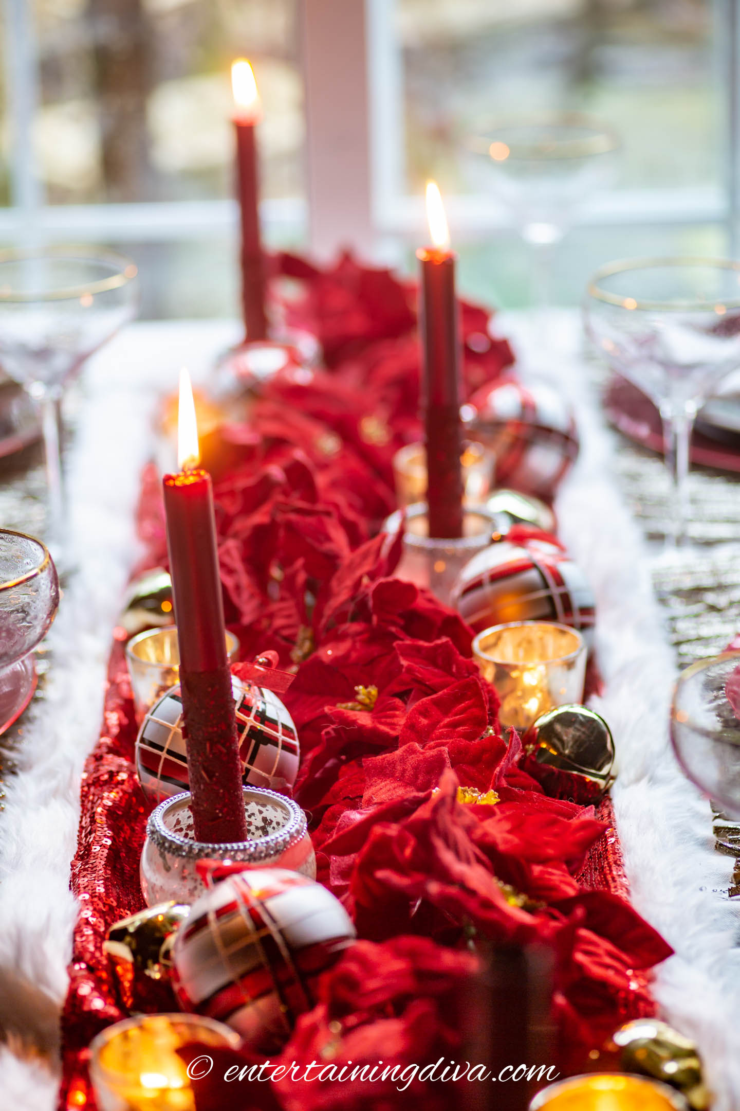 Red poinsettia centerpiece with red taper candles