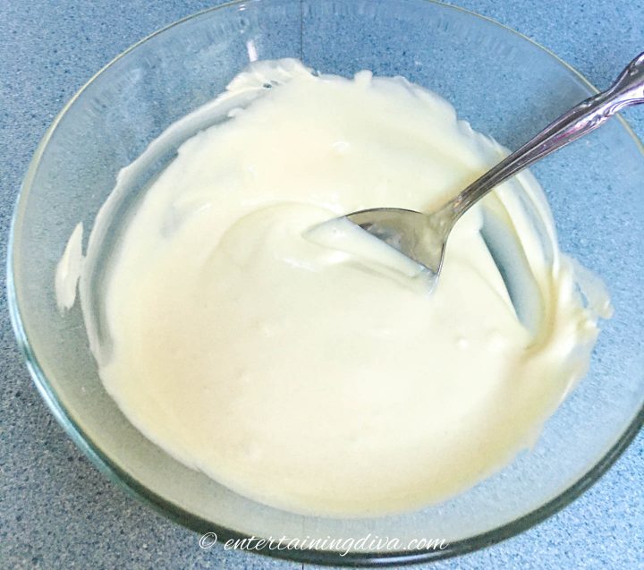 Melted white chocolate in a glass bowl