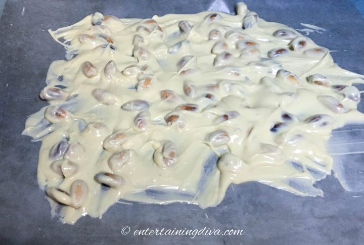 White chocolate almond bark spread out on a cookie sheet
