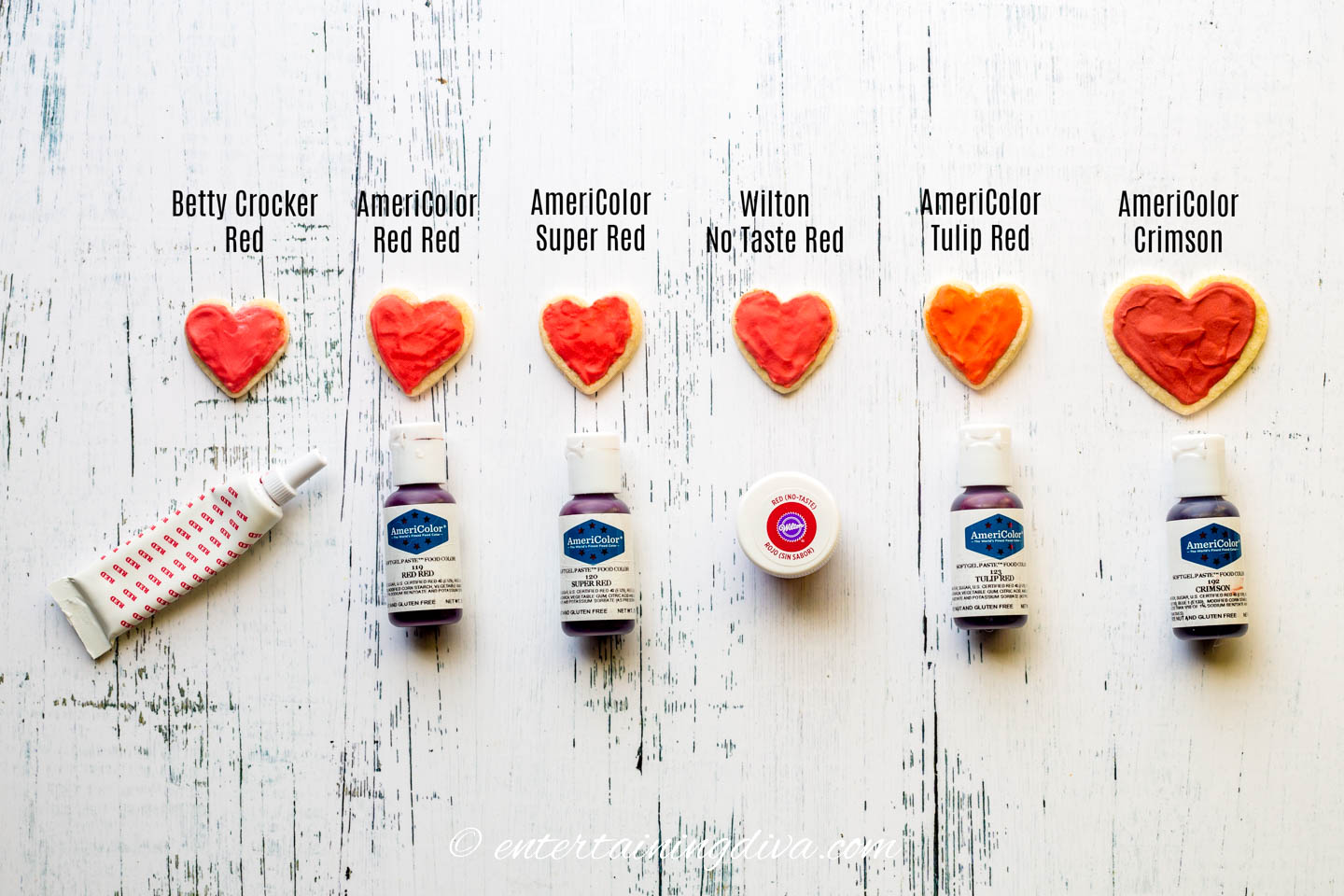 heart sugar cookies flooded with different red royal icing colors made with different food coloring brands