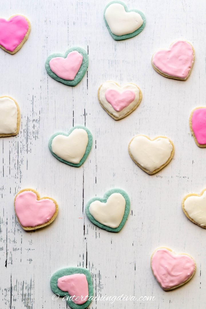 Heart cookies made with blue and white cookie dough, frosted with white and pink royal icing