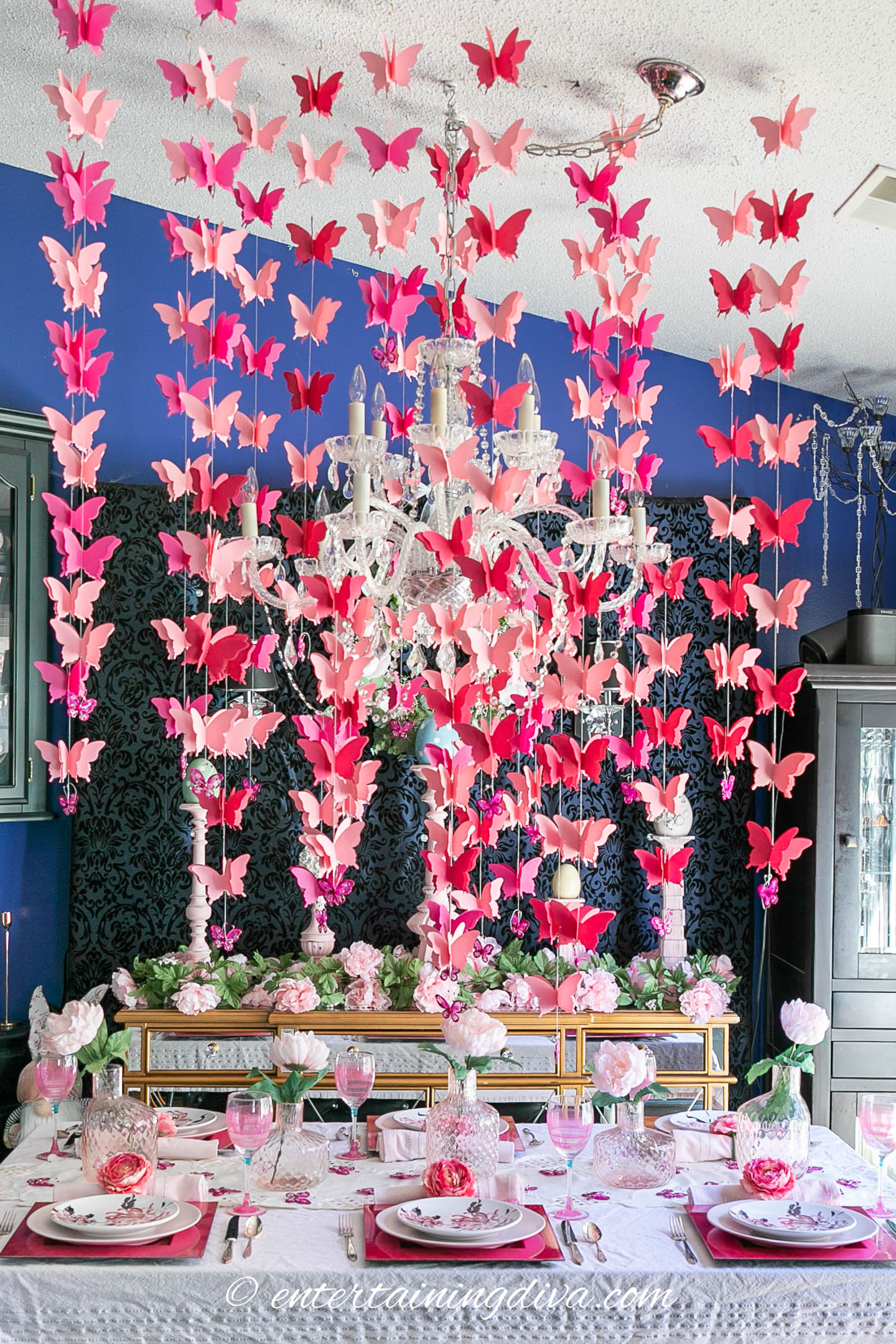 pink butterflies centerpiece hanging from the ceiling above the table