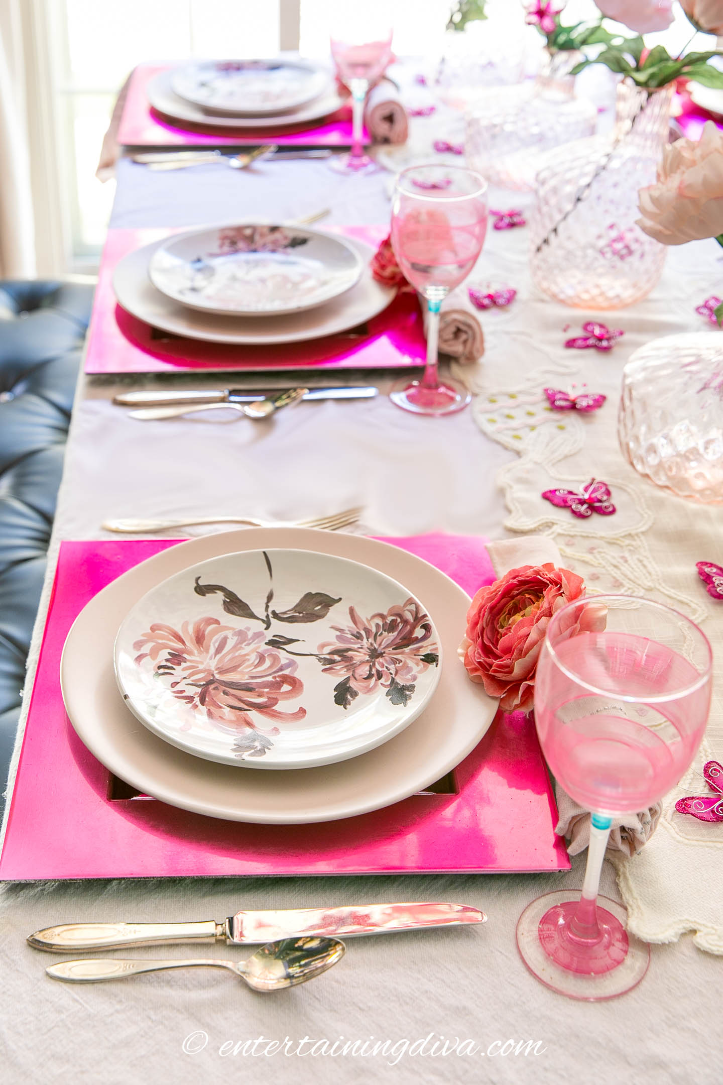 Lengthwise view of pink place setting with flowers and butterflies