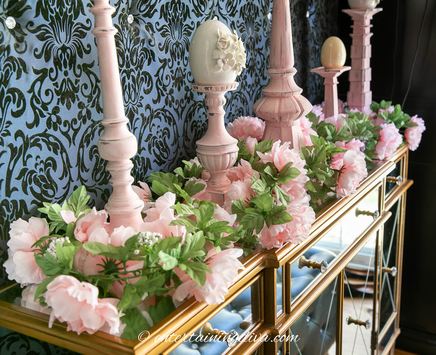 Faux pink peony garland on top of a buffet