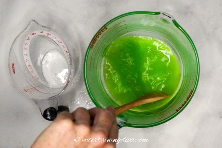 Top view of green apple Jello and boiling water being mixed