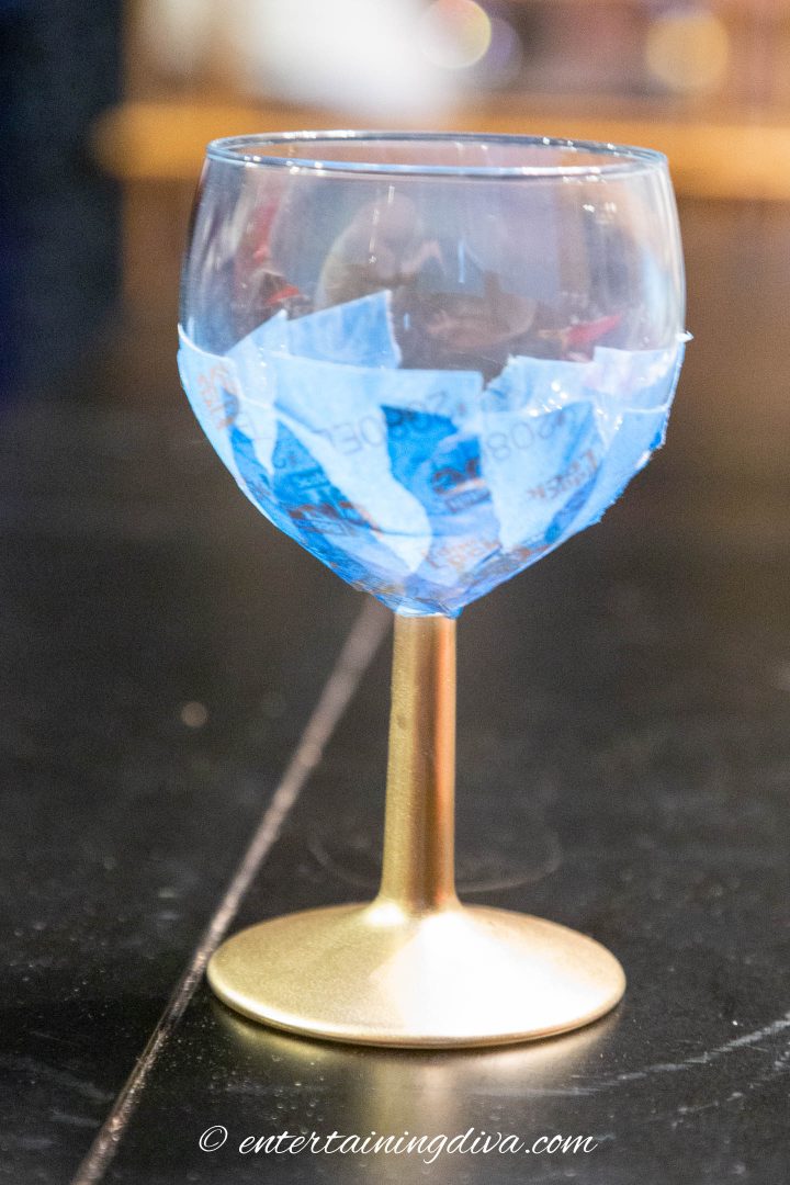 The wine glass with tape and the stem spray painted gold