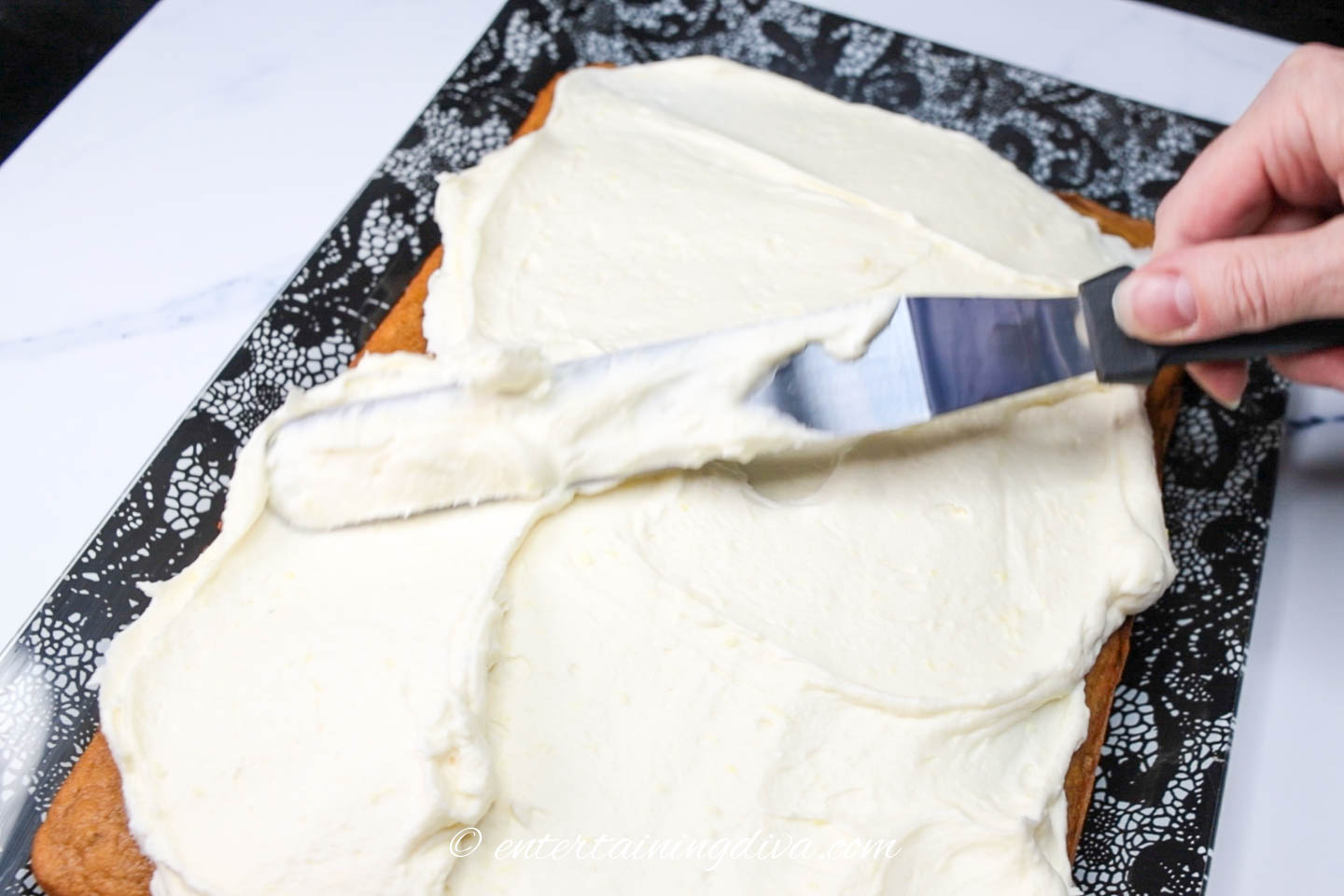 icing being spread on the cake
