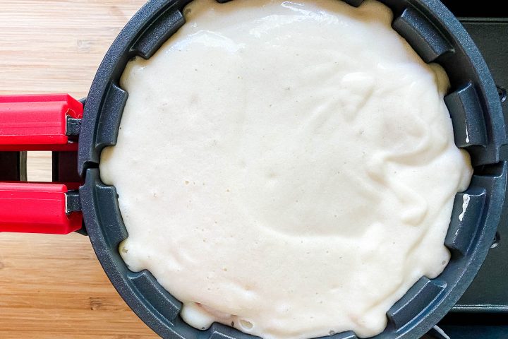 Stuffed waffle in a waffle iron ready to be cooked