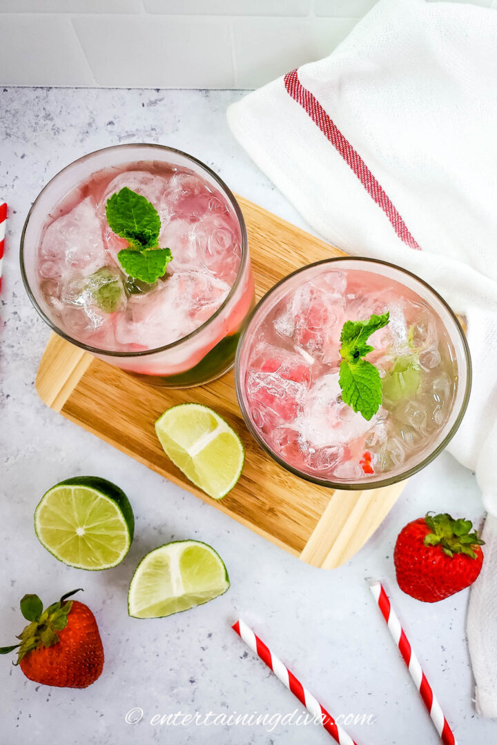 Overhead view of two strawberry mint mojitos with mint garnish