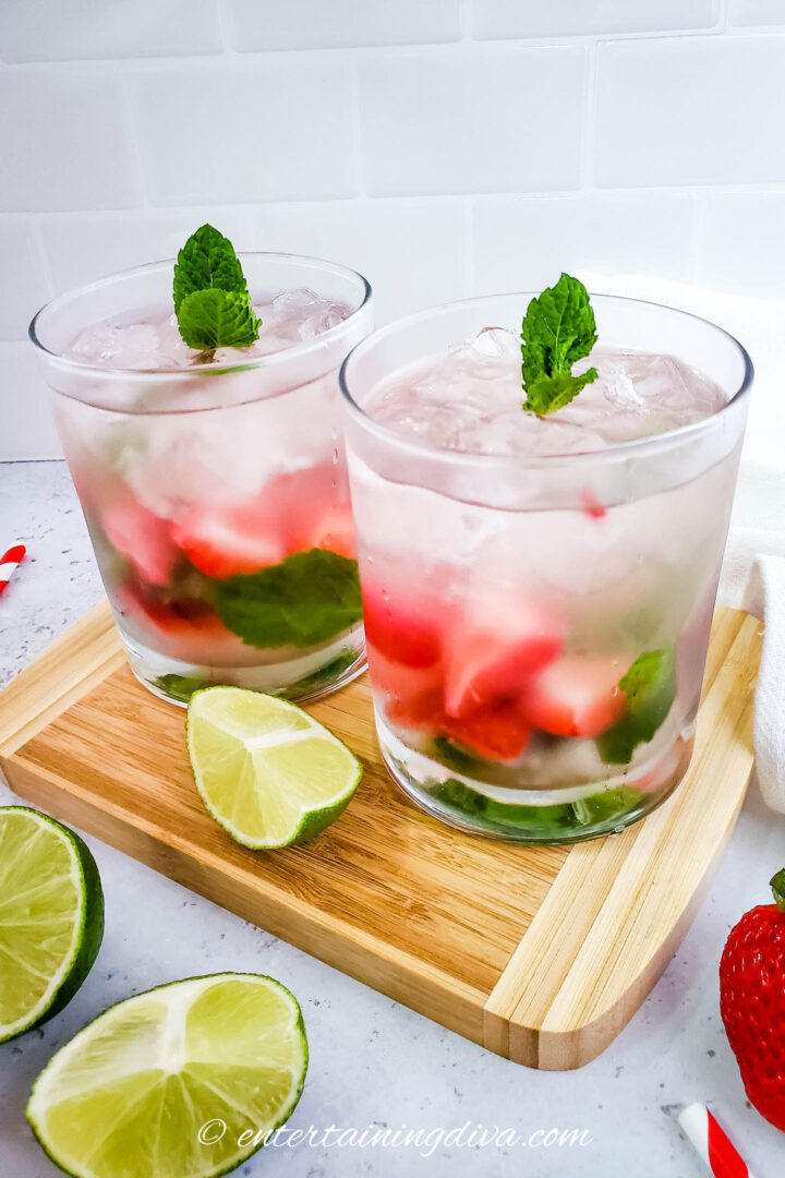 two glasses filled with strawberry lime mojito