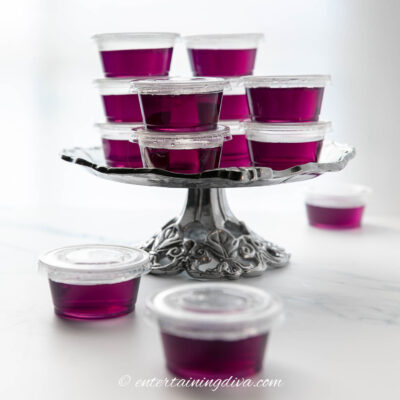Purple jello shots on a silver cake plate