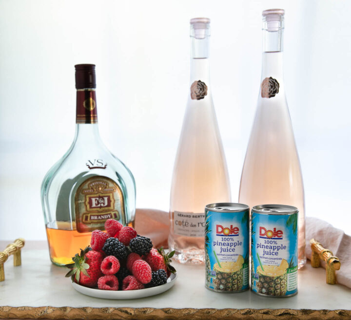 triple berry sangria ingredients - brandy, rose wine, pineapple juice and fresh berries