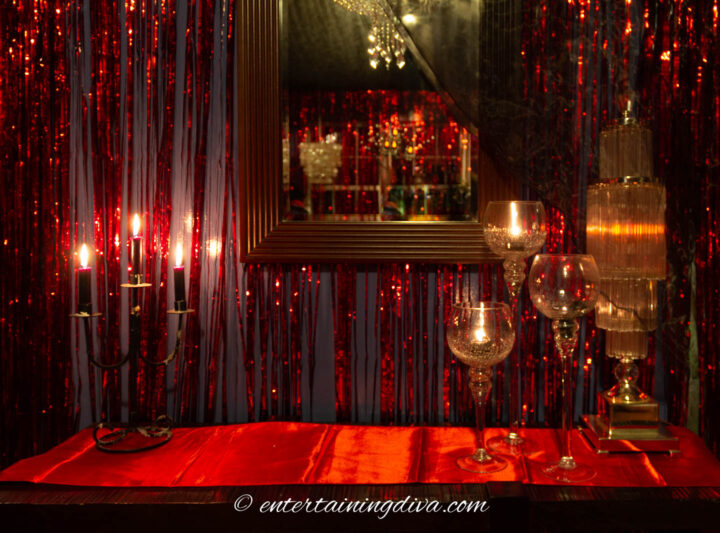 Fallen angels and devils party decor with candles and red table runner