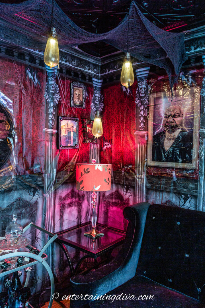 haunted mansion halloween party decor with a scene setter and old style hanging lights
