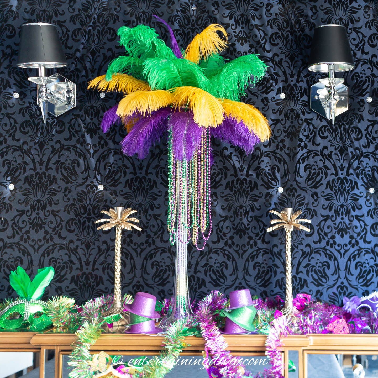 Mardi Gras party decorations made of purple, green and gold feather centerpiece and masks
