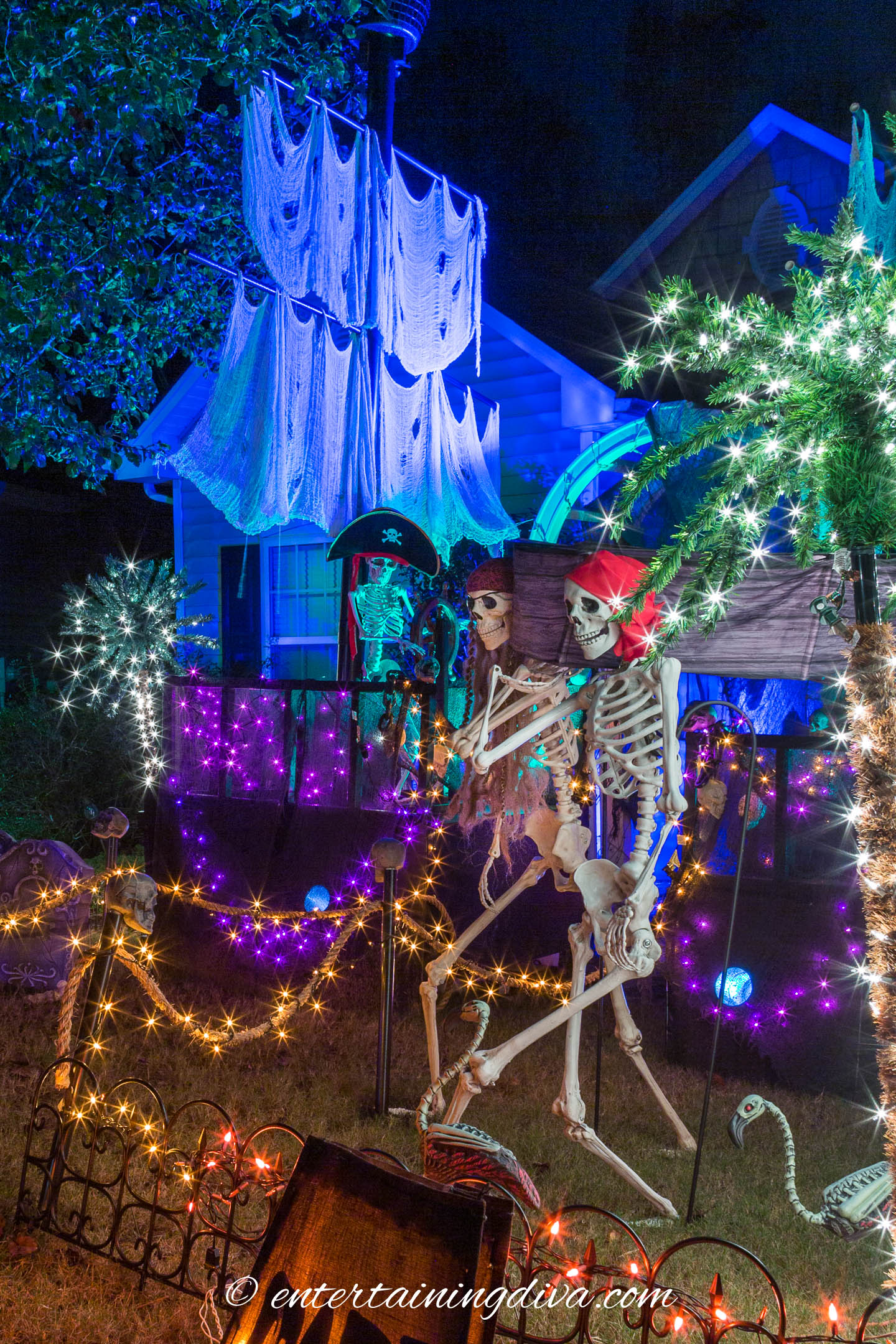 Pirates of the Caribbean outdoor Halloween decor with skeletons and a pirate ship