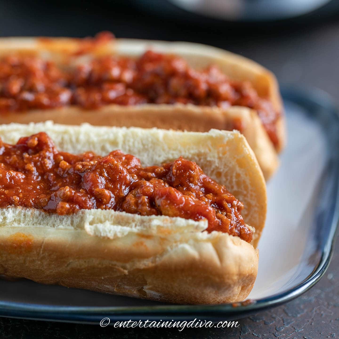 Two hot dogs topped with slow cooker beanless chili