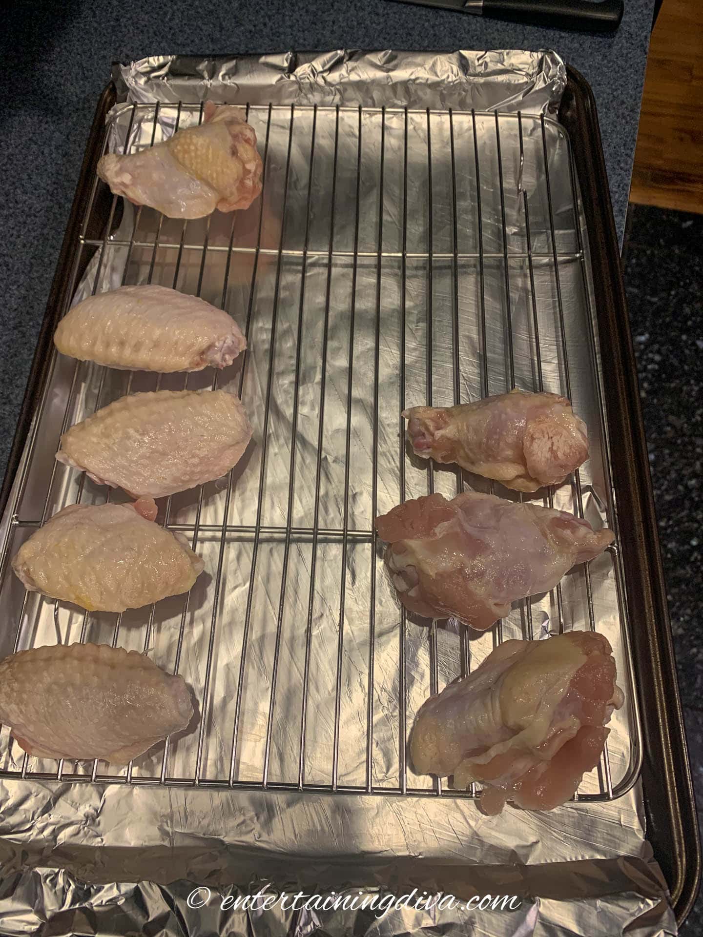 wings skin side up on a baking rack on top of a baking sheet