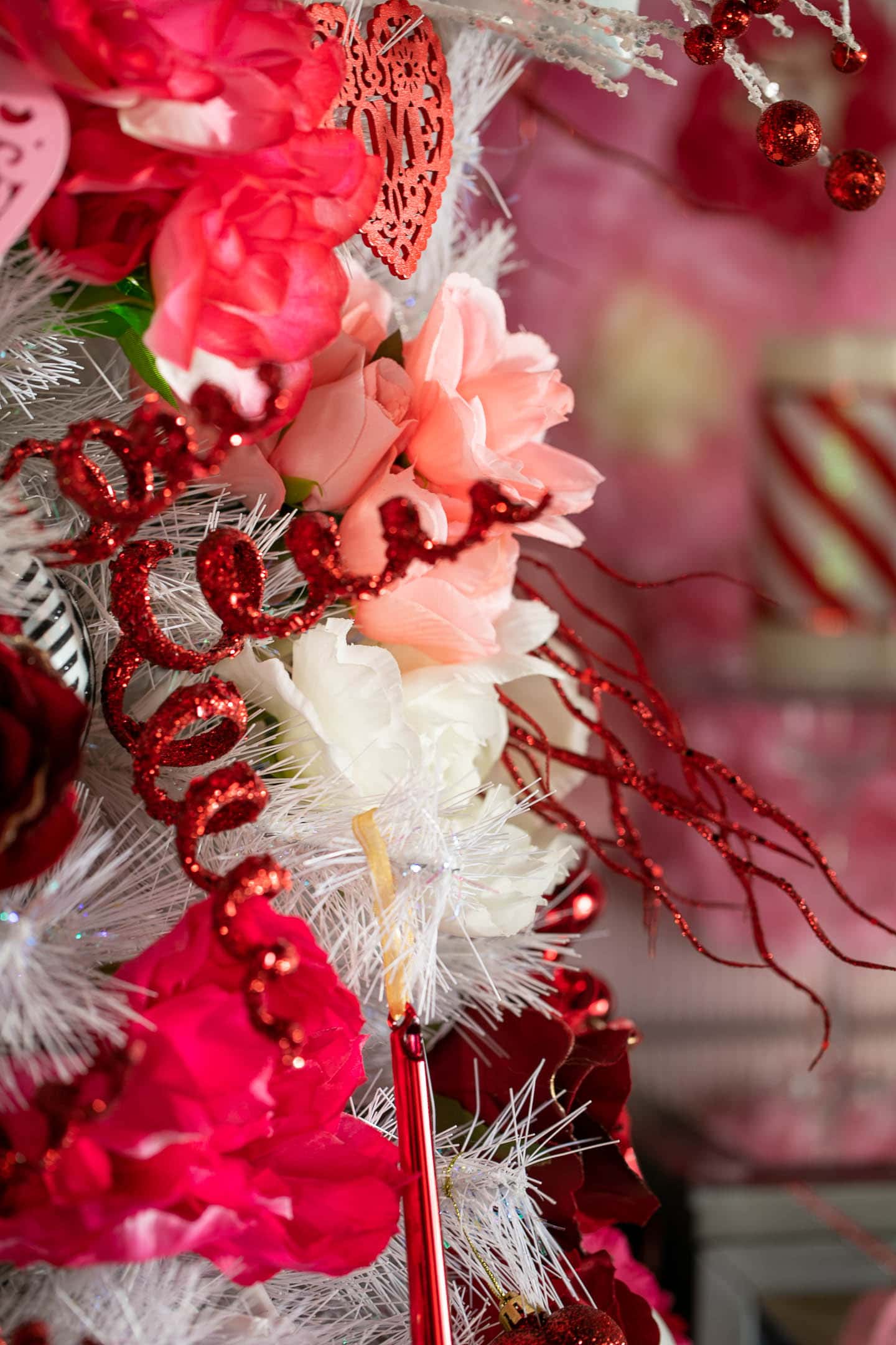 Close up of red, pink and white roses on a white Valentine's Day tree