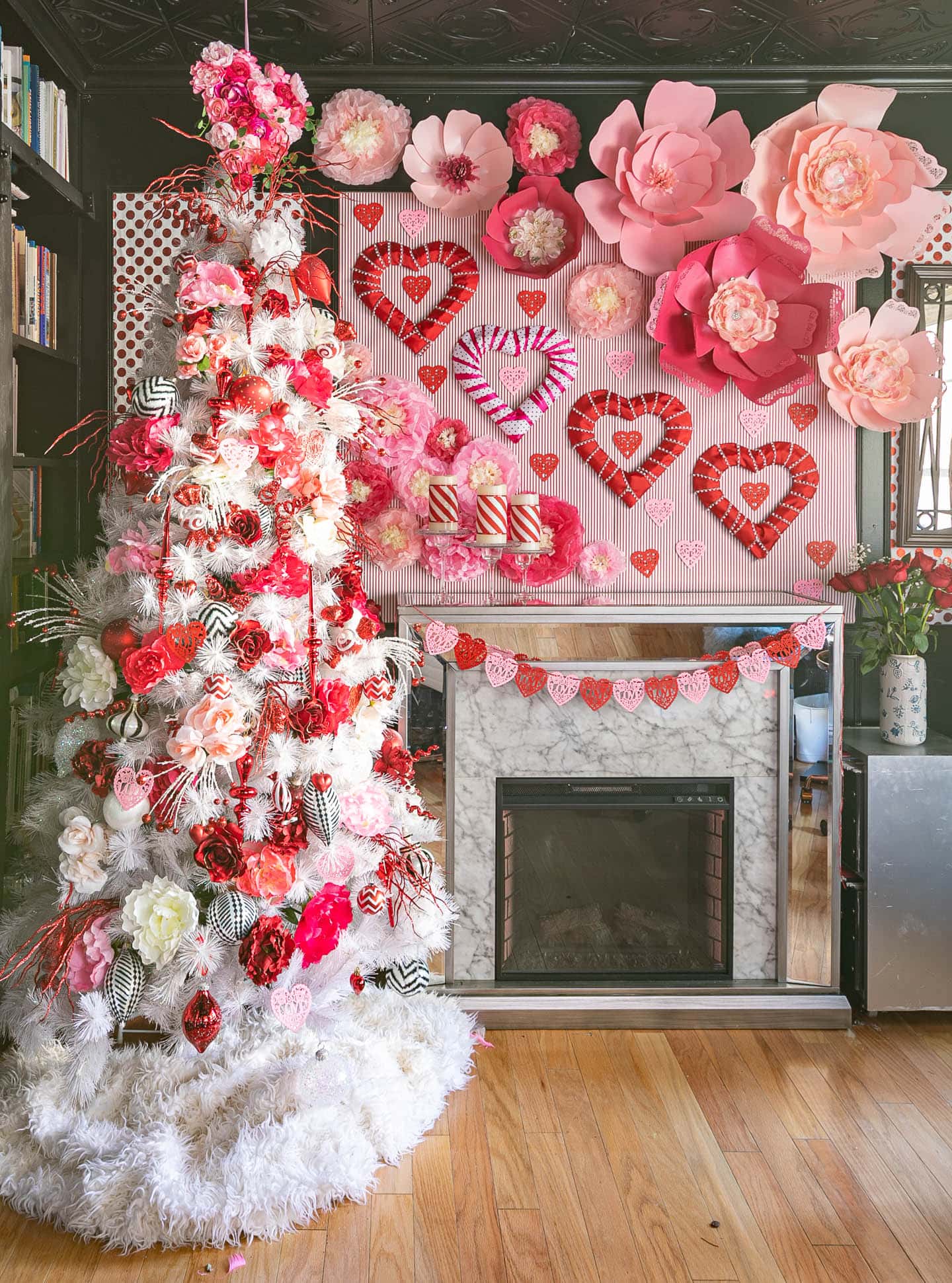 Hearts and roses Valentine tree beside a fireplace decorated for Valentine's Day