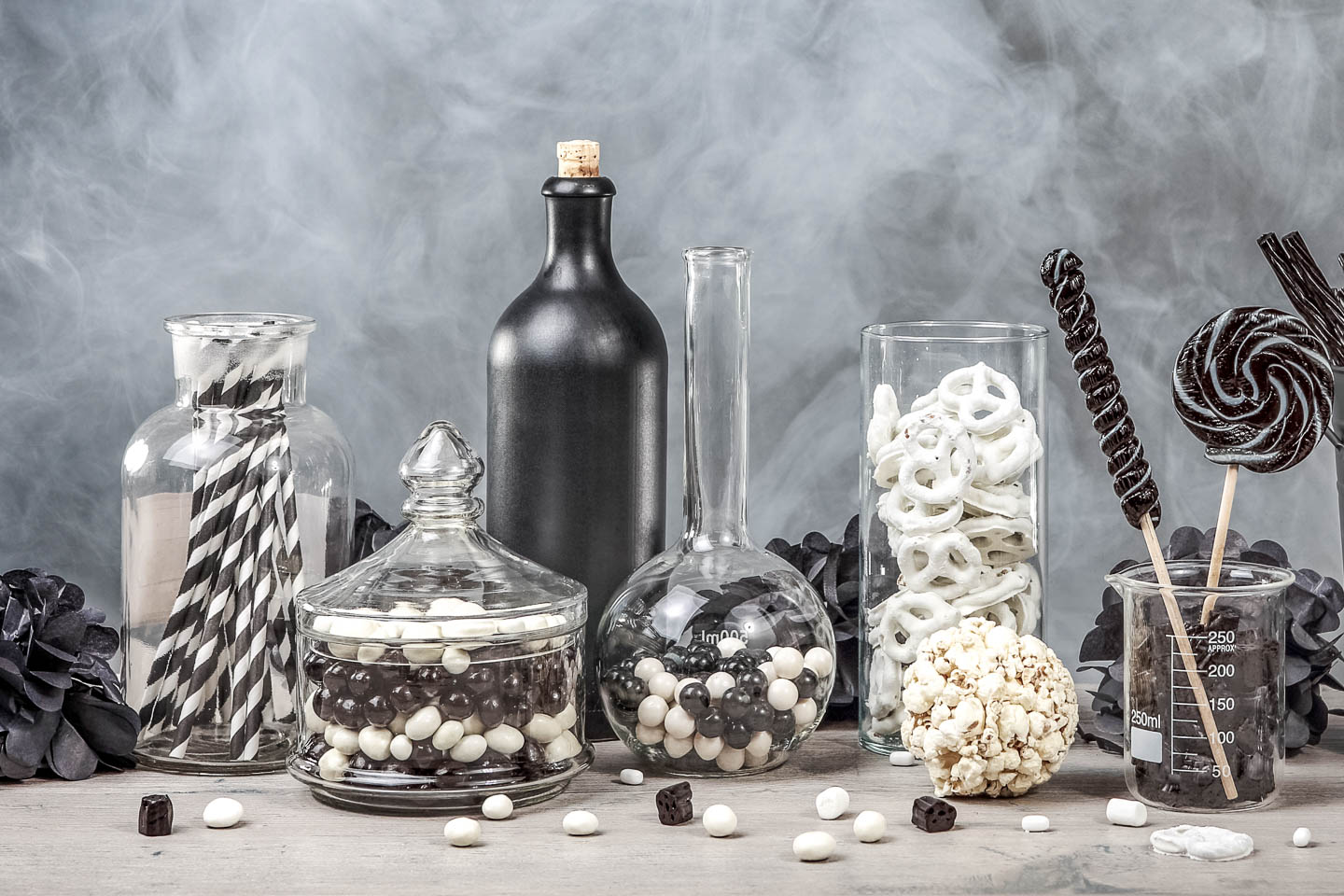 black and white candies in jars on a tabe