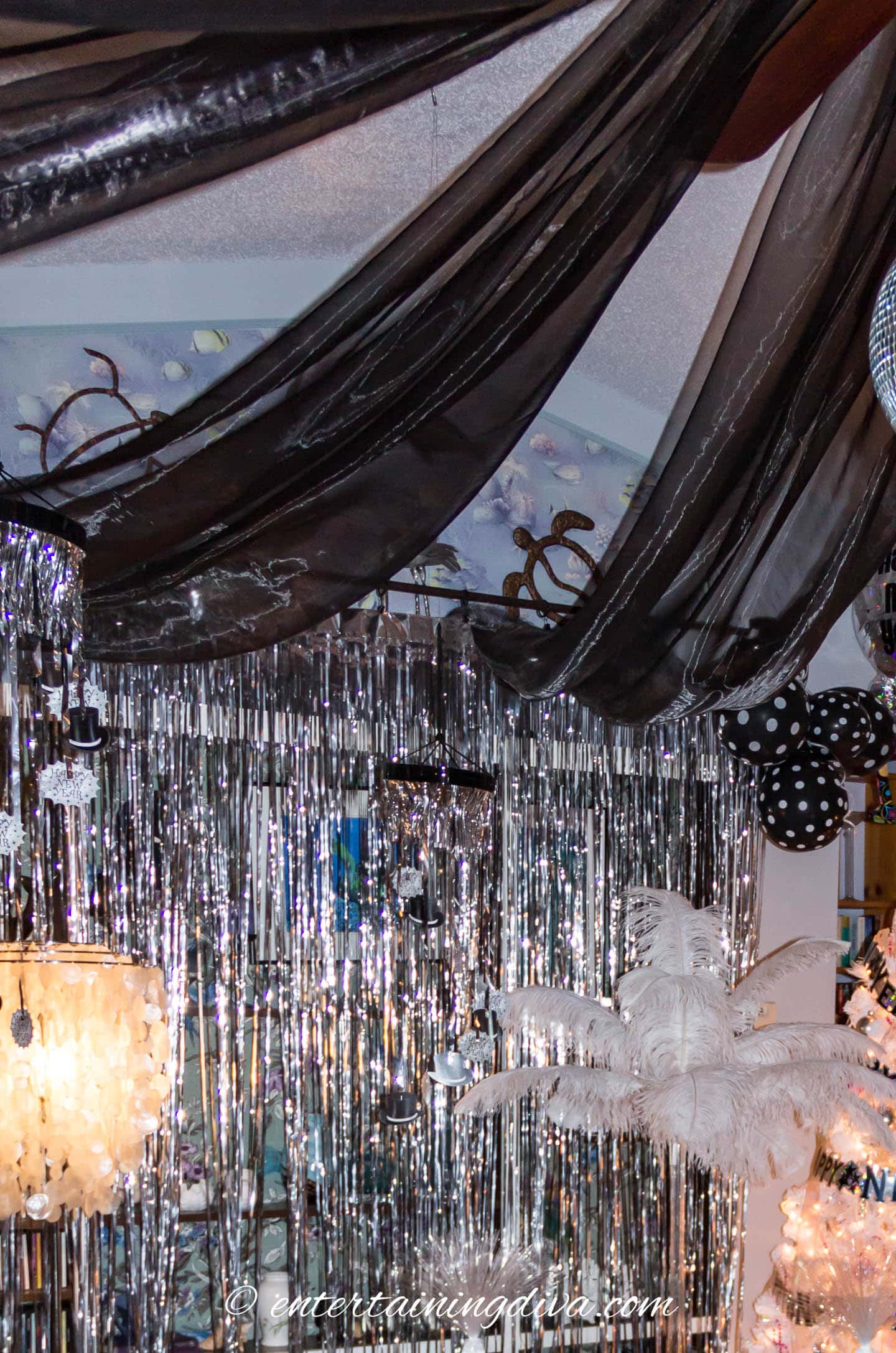 black ceiling swags attached to the walls with curtain rings on a rod