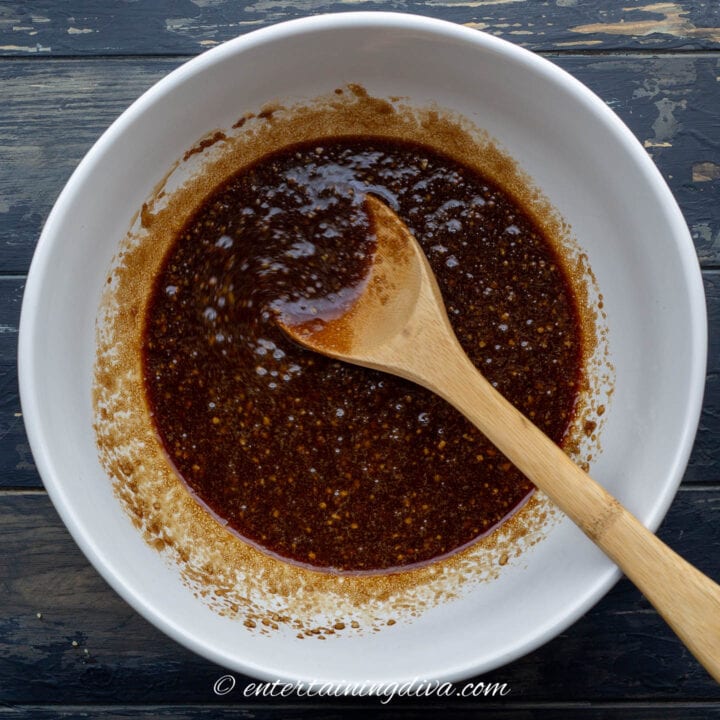 sticky Chicken wing sauce in a bowl with a spoon