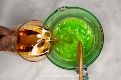 Fireball and apple juice being poured into apple gelatin
