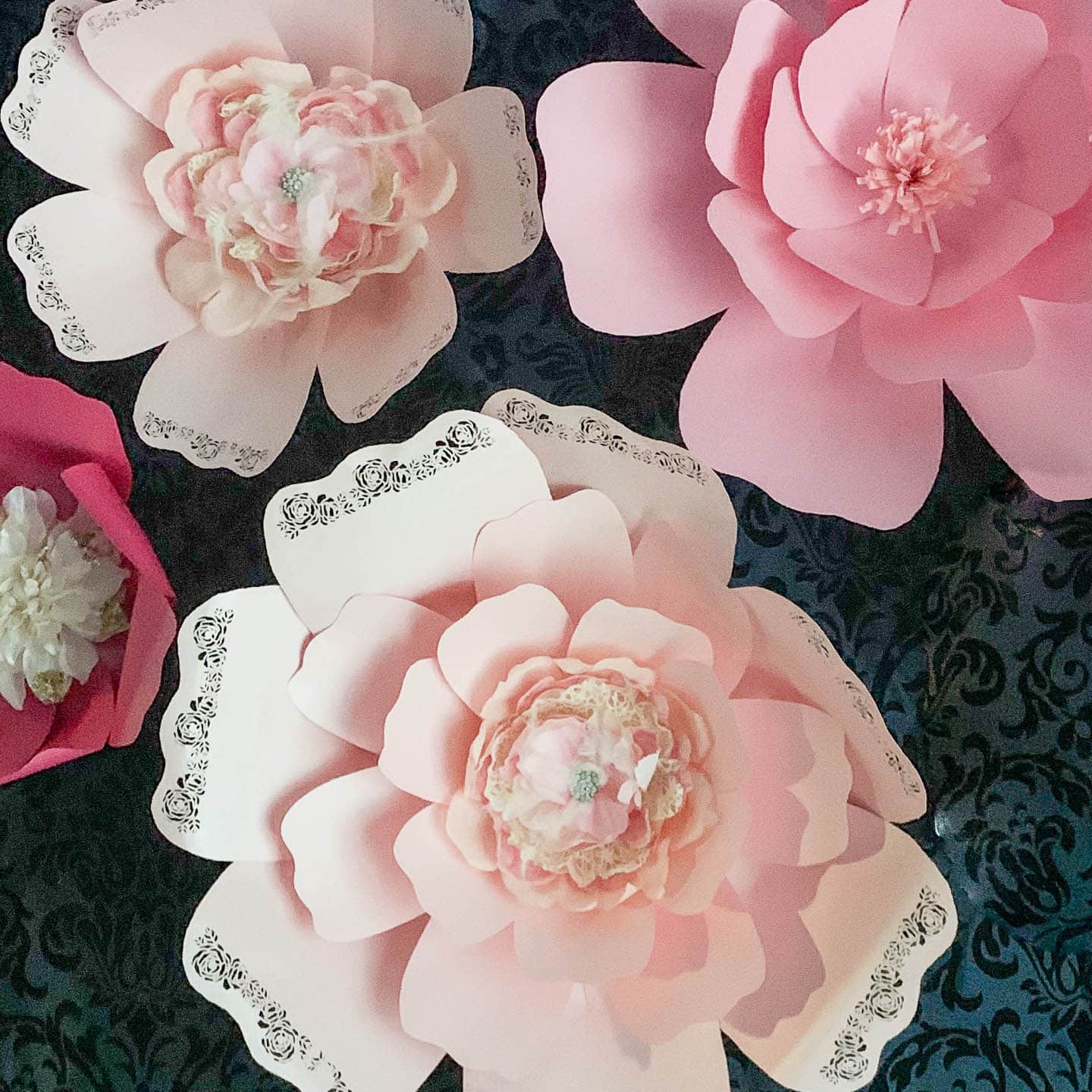 DIY giant paper flowers hung on a wall