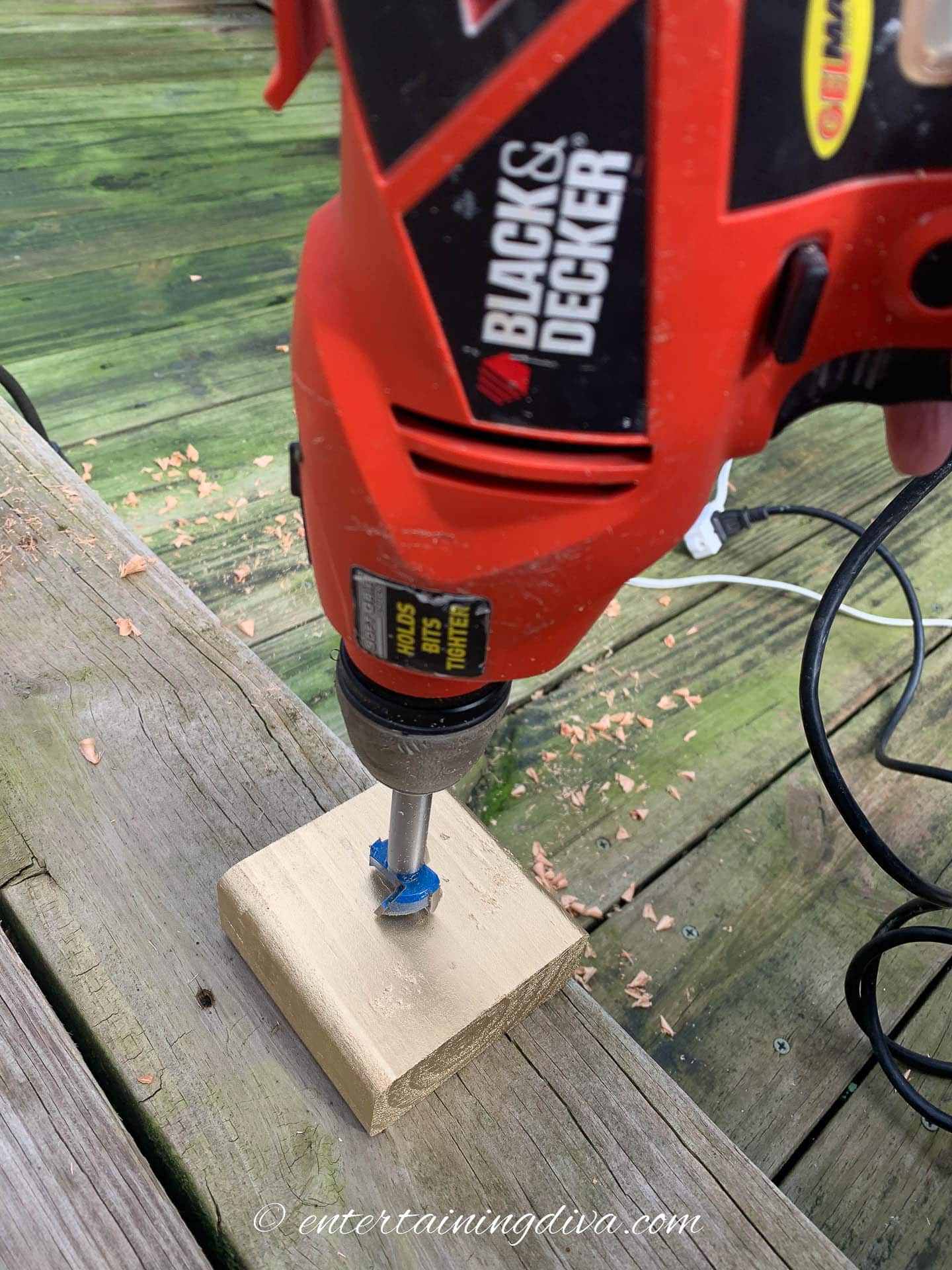 3/4 inch hole being drilled in a block of wood