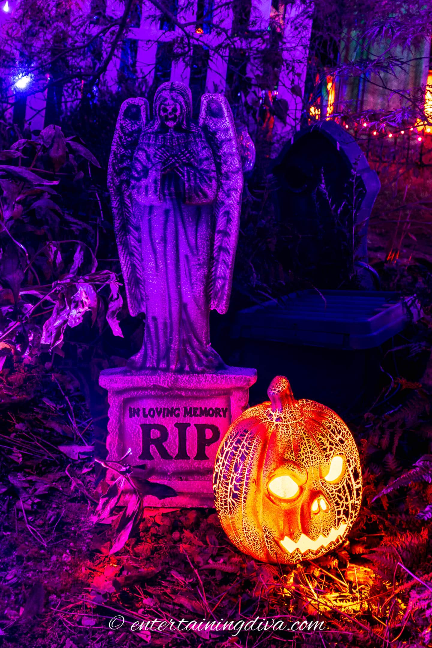 Halloween pumpkin in front of gravestone