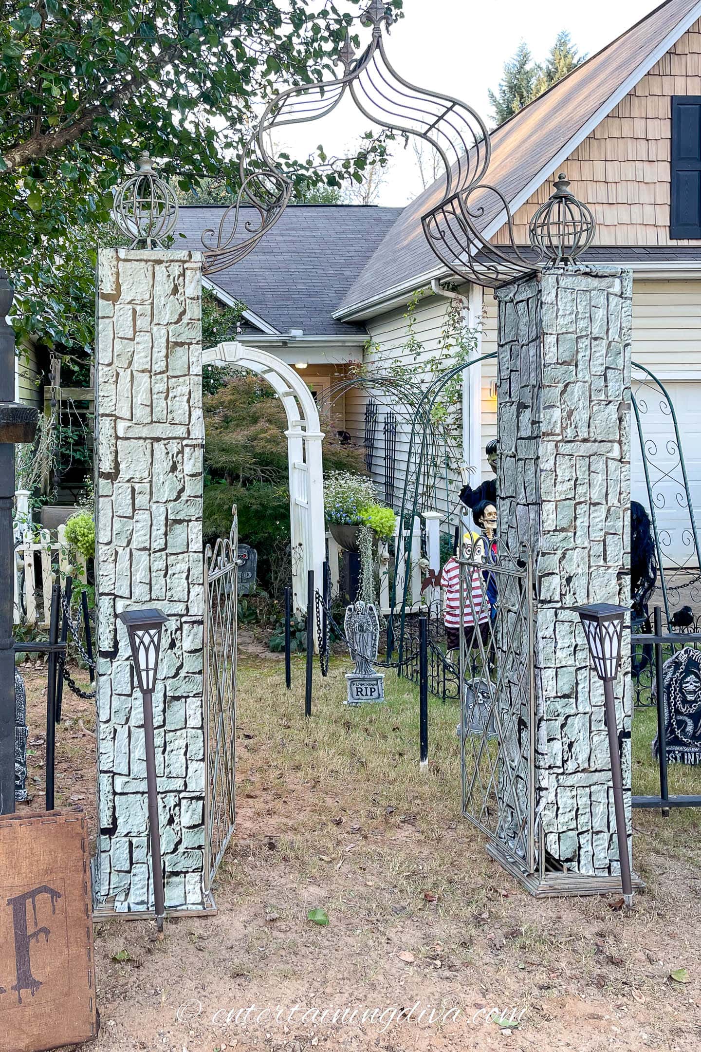 A garden arbor with the posts wrapped in brick scene setter