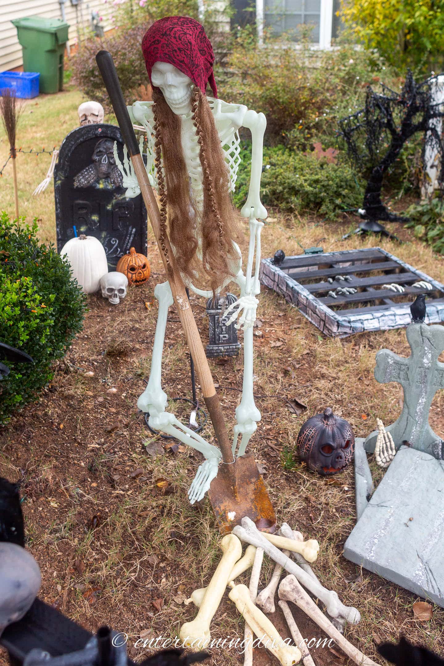 A skeleton with a shovel in a Halloween graveyard