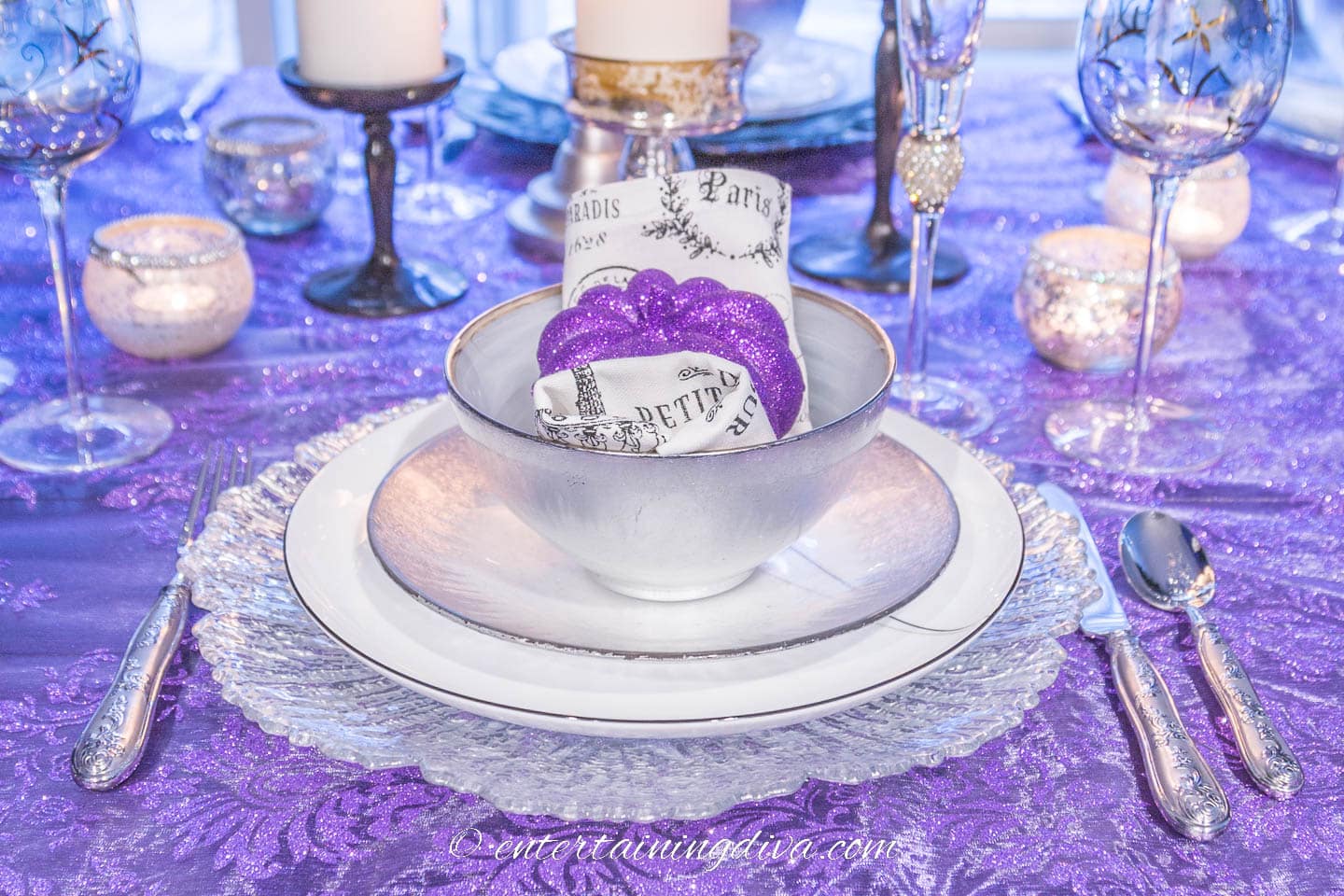 white and silver place setting with a faux purple pumpkin on top