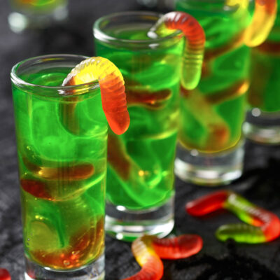 Green Halloween jello shots mixed with gummy worms